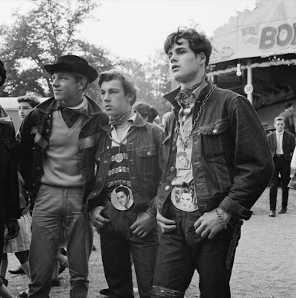 Three men in jeans and trucker jackets. 