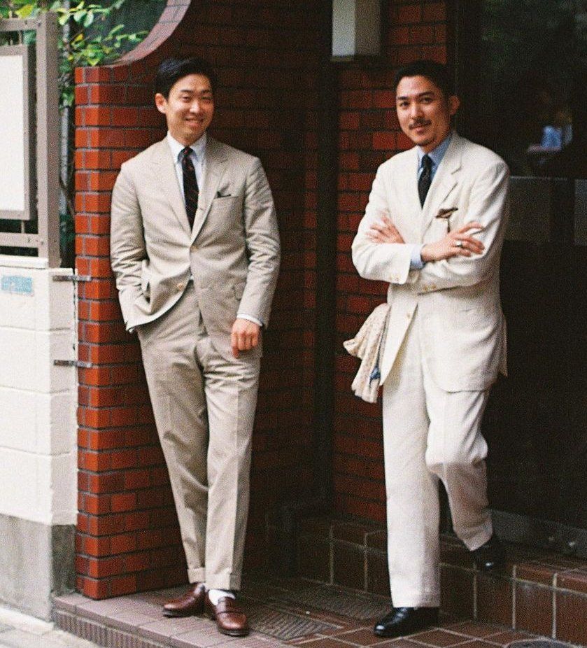 Two Japanese men wearing tan suits.