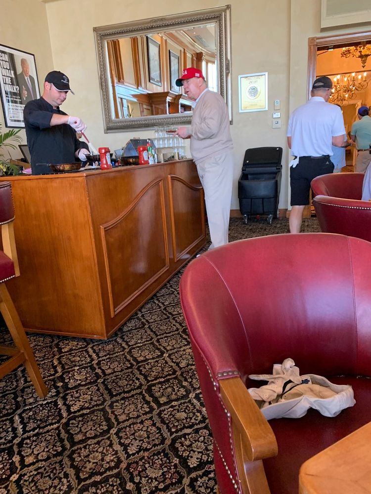 Trump in a beige v-neck merino sweater and beige chinos. 