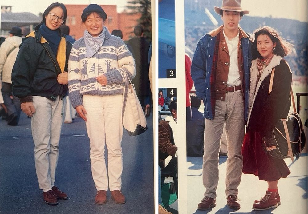 A woman wearing a green jacket with jeans. And a woman wearing a grey-white Cowichan sweater with white jeans. Also a man wearing a denim chore coat with a brown jacket and grey jeans. And a woman wearing a sherpa-lined jacket with a red skirt. 
