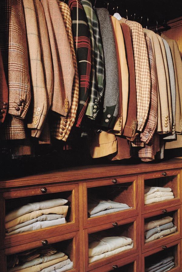 Racks of colorful sport coats and some button-up shirts in an assortment of colors. 