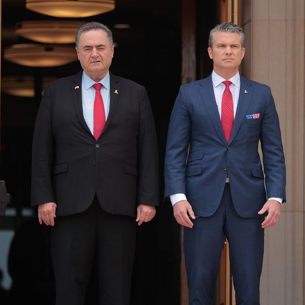 The same man in a navy suit. The sleeves are too short and the jacket is a bit too short and tight. 