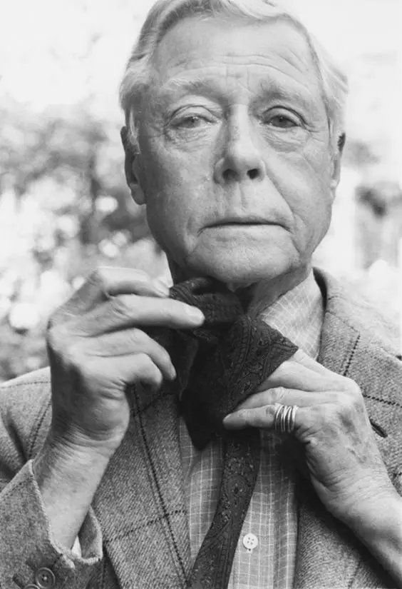The Duke tying a tie. 