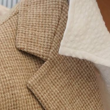 A close up of the jacket's gorge. The pattern matches across it. 