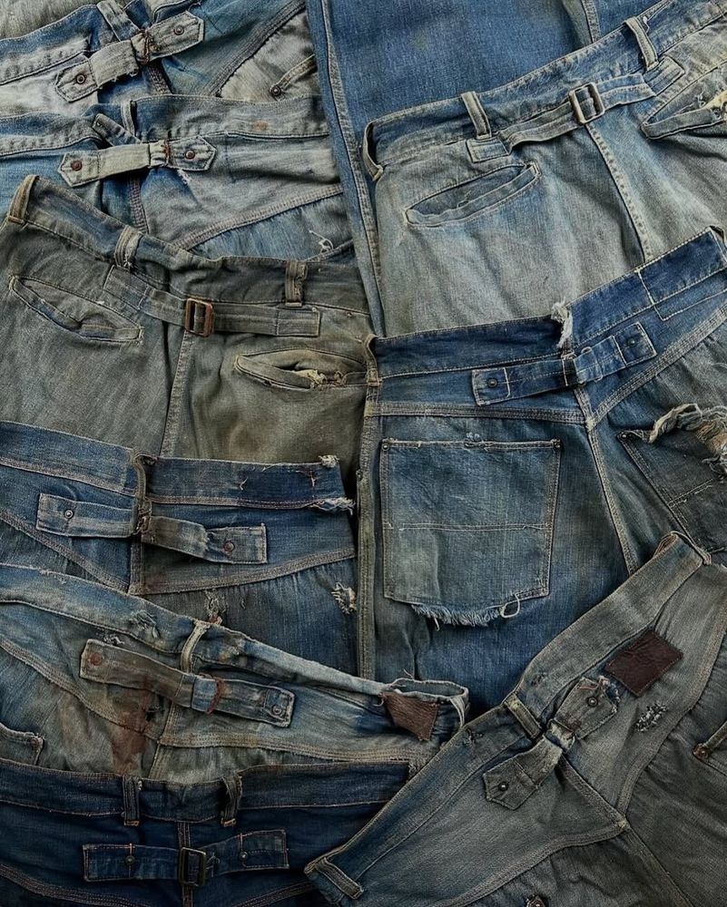 A pile of naturally faded vintage jeans. 