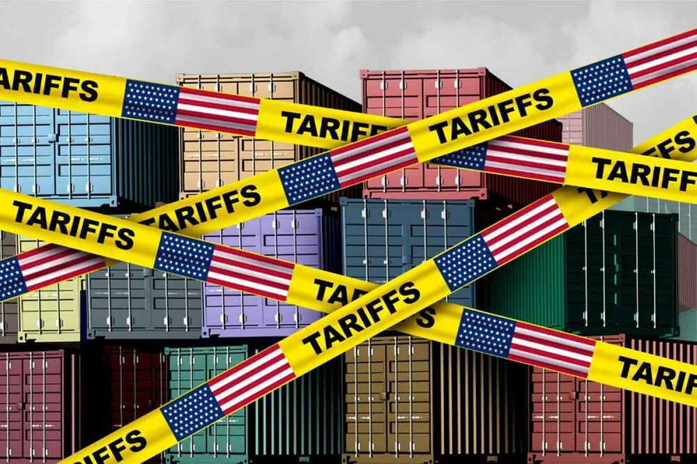 Photo of overseas shipping containers stacked on top of each other. There is yellow tape all over the graphic that says "Tariffs."