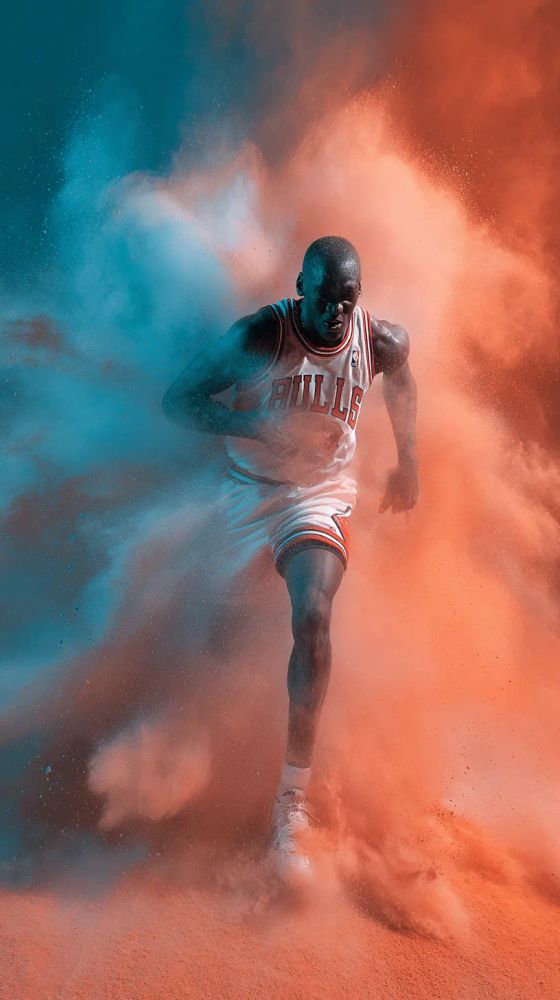 A dramatic portrait showcases Michael Jordan in action, enveloped by colorful powder. He’s mid-stride, powerfully running forward. He’s wearing a white Chicago Bulls jersey with red trim and "BULLS" emblazoned across the chest. His expression is intense, focused downward. Vibrant clouds of blue and orange powder surround him, partially obscuring his form as if he's bursting through a wall of color. The lighting is dramatic, creating strong shadows that accentuate his muscular physique. The composition is dynamic, conveying a sense of energy and motion. The backdrop is a gradient of blue and orange.