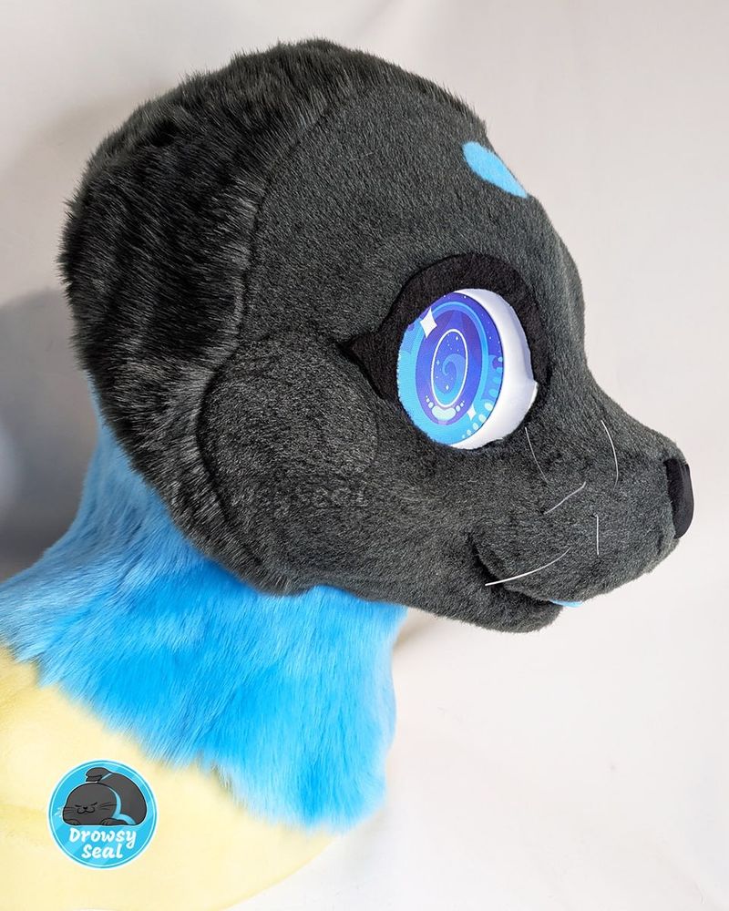 Grey and blue ribbon seal fursuit head, from the side