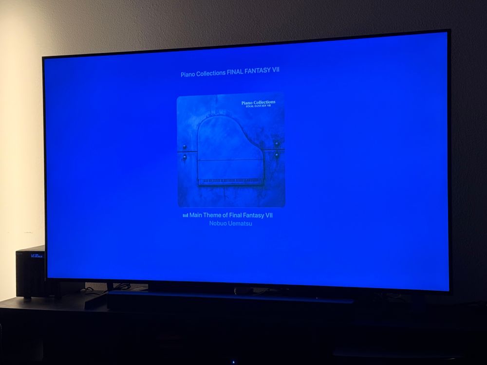 TV with Final Fantasy VII Piano Collections album cover with Main Theme playing.