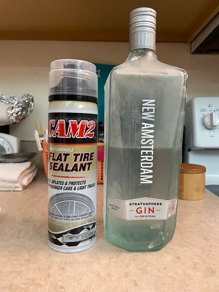 can of fix-a-flat beside cheap gin