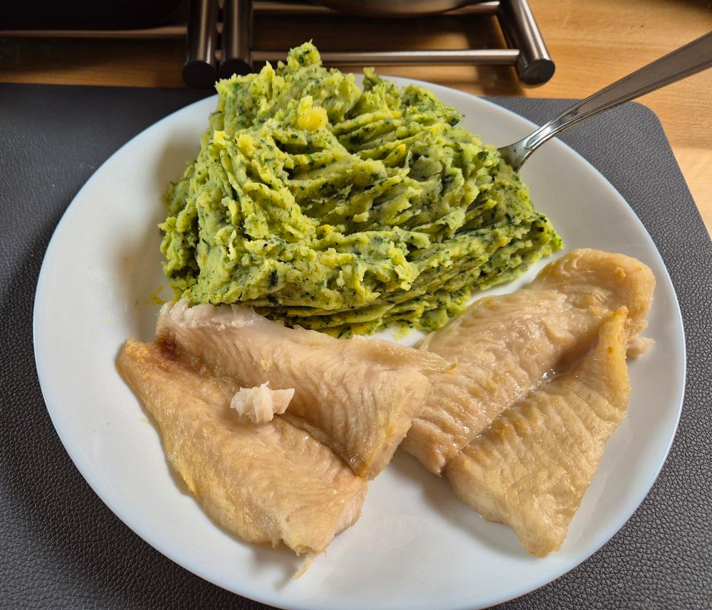 Plate with mashed potatoes with spinach and fish