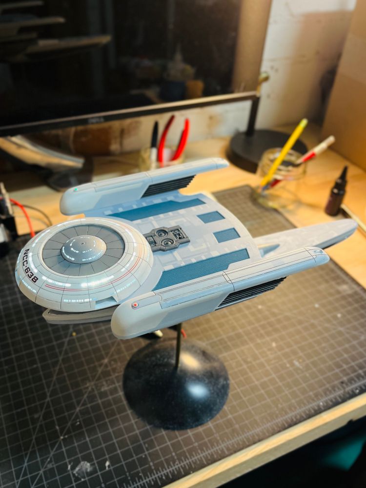 Fore/side view of a fully assembled model kit of the USS Grissom from Star Trek. 