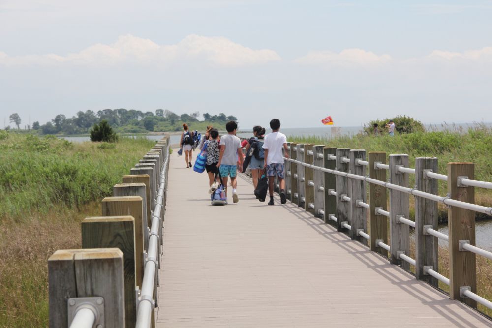 People on a walkway to the beach