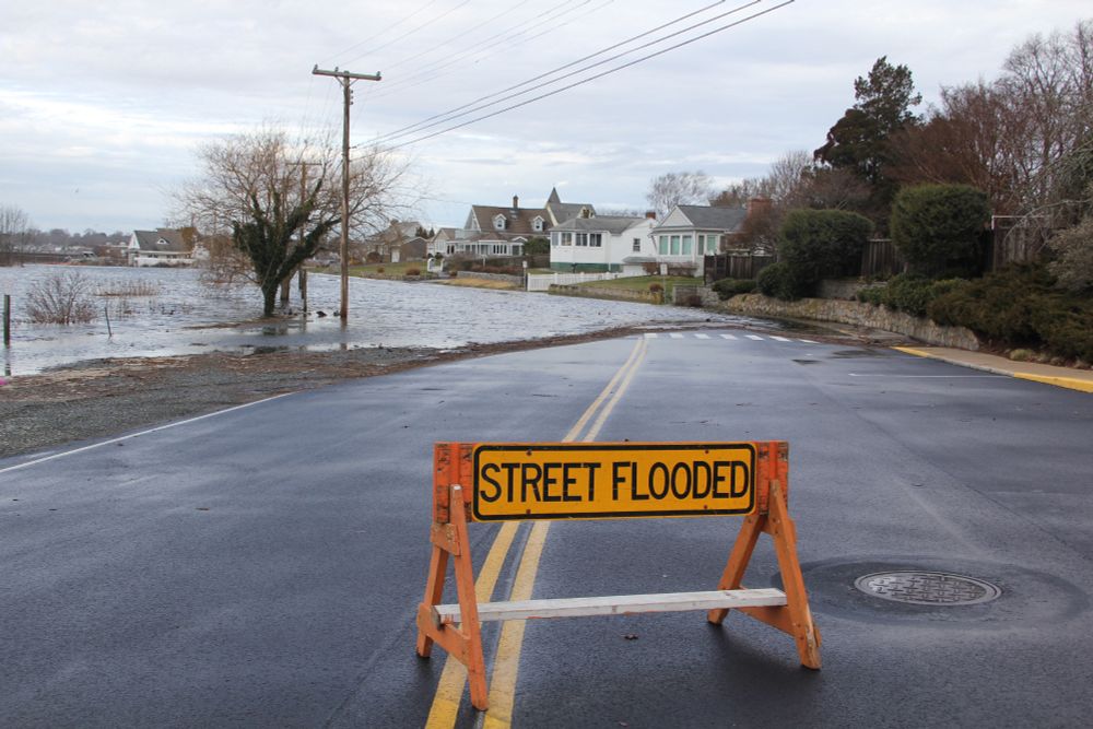 Road in Groton, CT, with "street flooded" barrier