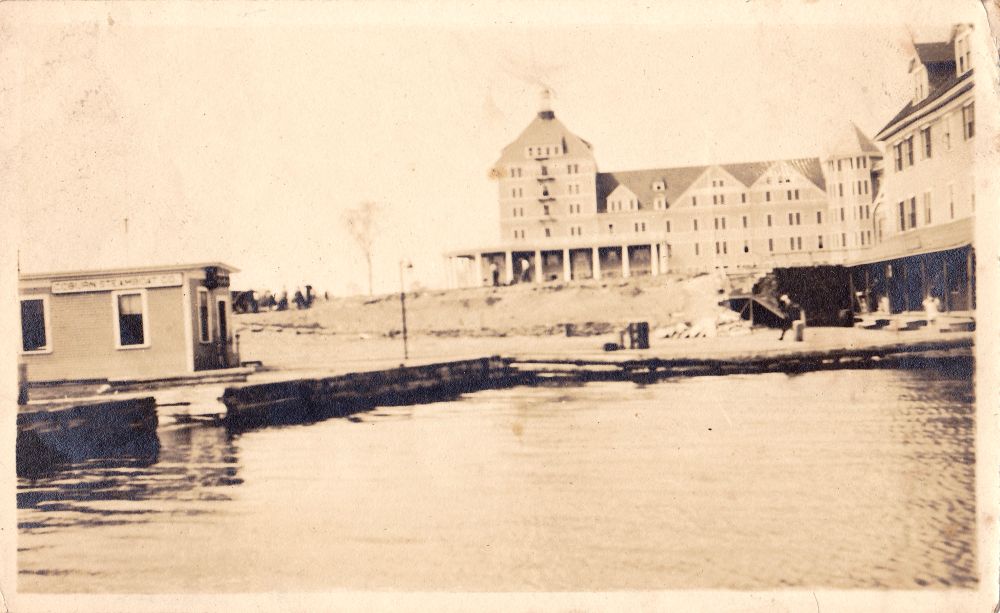 Coburn Steamboat Co., a company that operated on the Moosehead Lake in Maine, early 1900s, multi-story buildings on shoreline, sepia tone