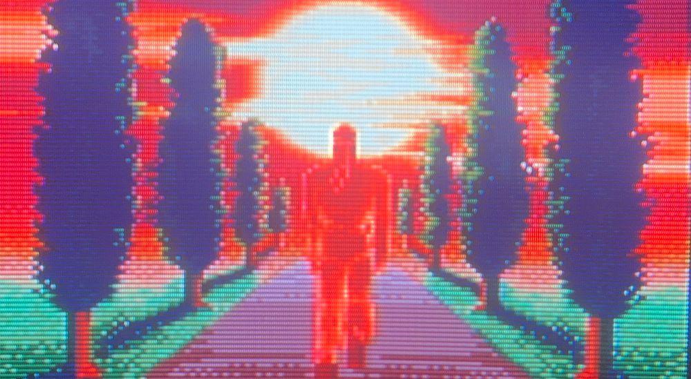 Ryu steps into the bright sunlight past a row of trees on each side of him, facing whatever challenge comes next 