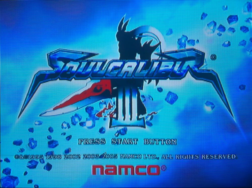 title screen with waves of blue and lighting crackling around the logo. after clearing the story mode the title will be announced by the character you were using // Soul Calibur 3 for Playstation 2, photography on CRT TV 