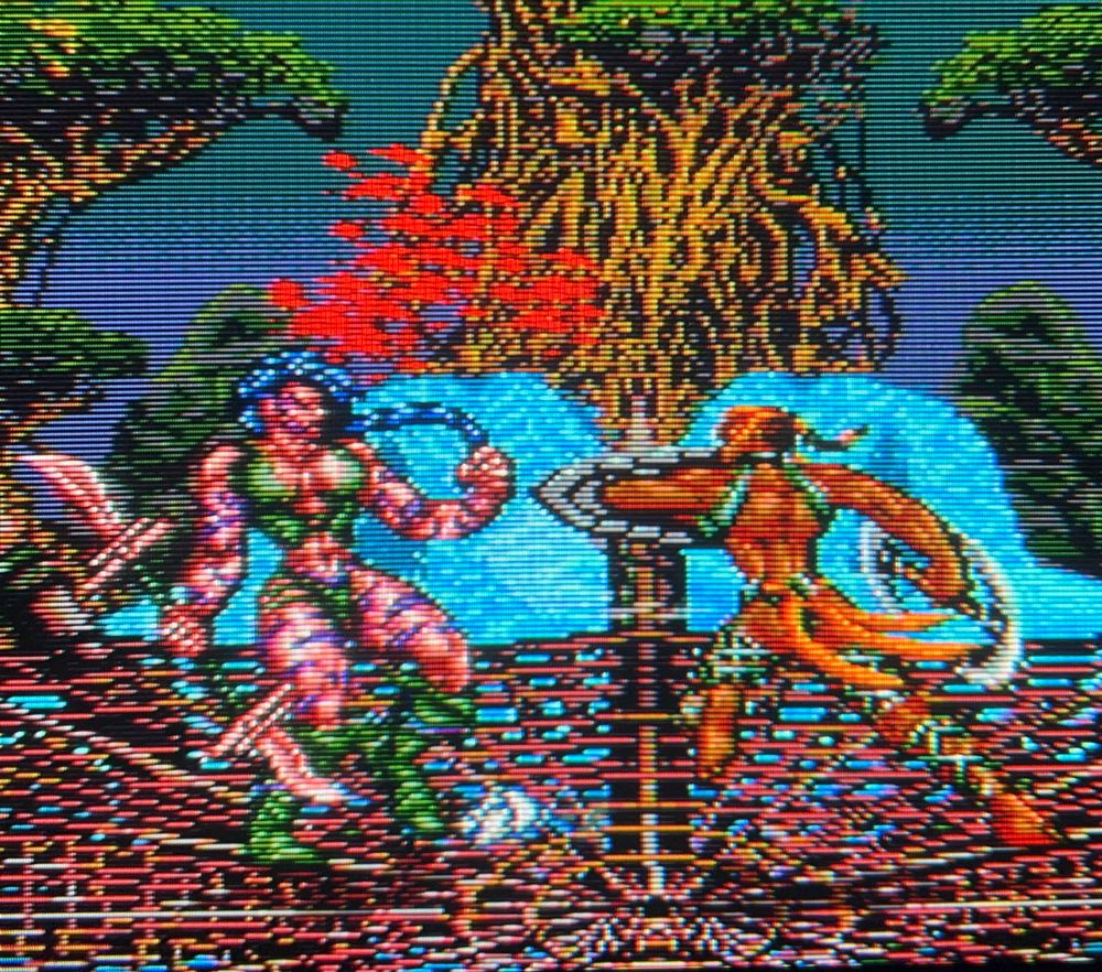 Talazia swipes Divada with the edge of her blade and a spout of blood shoots off of her as she recoils from the damage 