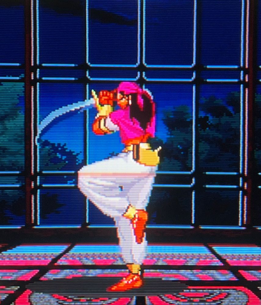 Sinclair poses with sword in hand, her stage is dramatically lit by lightning through the glass window pane behind her 