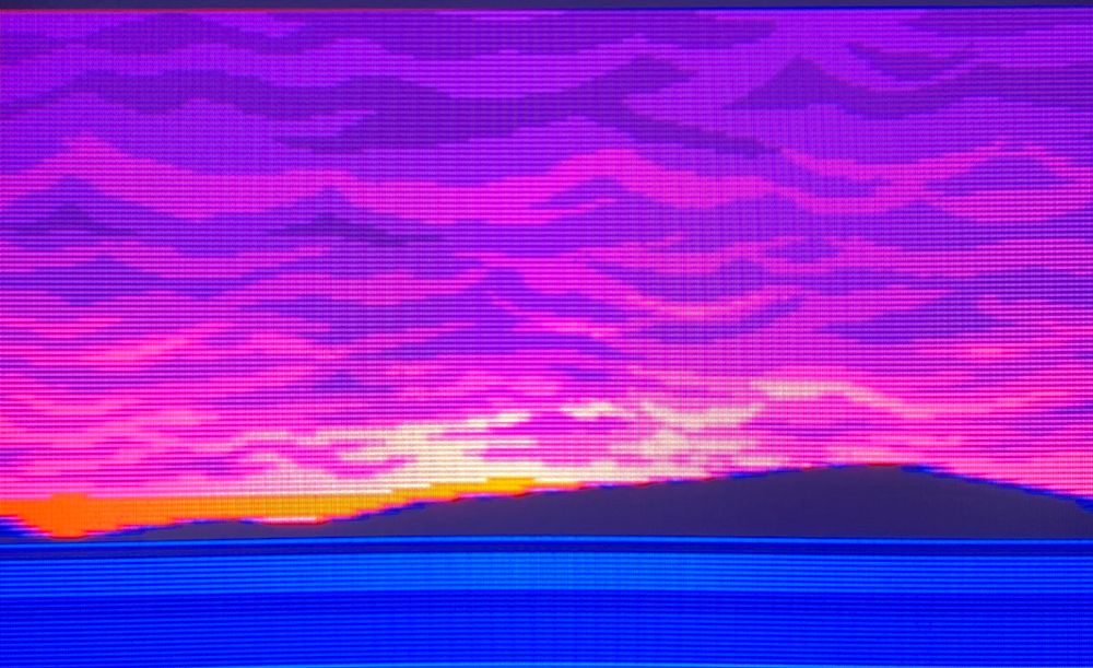purple clouds are pitted with deep violet pockets as they expand over the sky. the sun shining over a nearby hill sends rivers of light spreading out through their pillowy mass // The Space Adventure: Cobra the Legendary Bandit for Sega CD, photography on CRT TV 