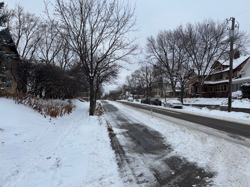 Sidewalk uncleared, bikeway and street cleared of snow