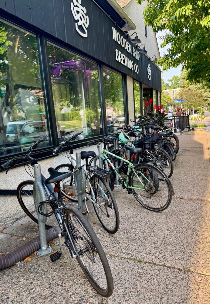 A dozen bikes are parked out front of Wooden Ship Brewing