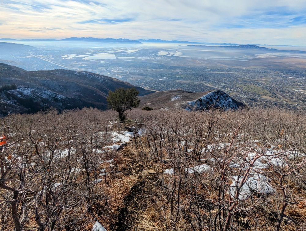 Coming down Wolverine trail; Davis county starting to develop a temperature inversion. Antelope Island and the Great Salt Lake in the middle/right distance.