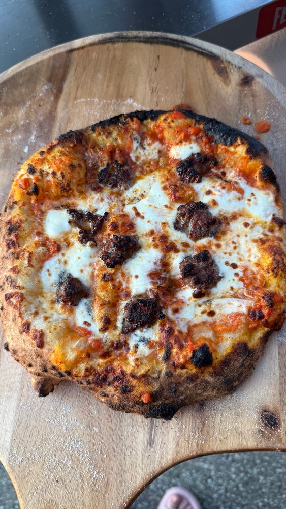 Tomato sauce, mozzarella, and rocky rococos sausage 