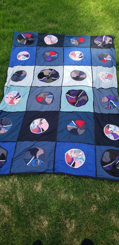 Blanket with a design that incorporates old cloth masks