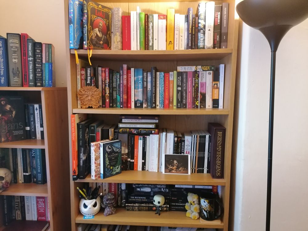 Bookshelves containing folk horror. Variety including:
Midnight Sun - Ramsey Campbell
Harvest Home - Thomas Tryon
The Ceremonies - T.E.D Klein
Gallows Pole - Benjamin Myers
Starve Acre, Devil's Day, Barrowbeck - Andrew Michael Hurley
Wicker Man - Robin Hardy and Michael Shaffer
Blood on Satan's Claw - Robert Dunne Simmons
Swansong - Kerry Andrew
