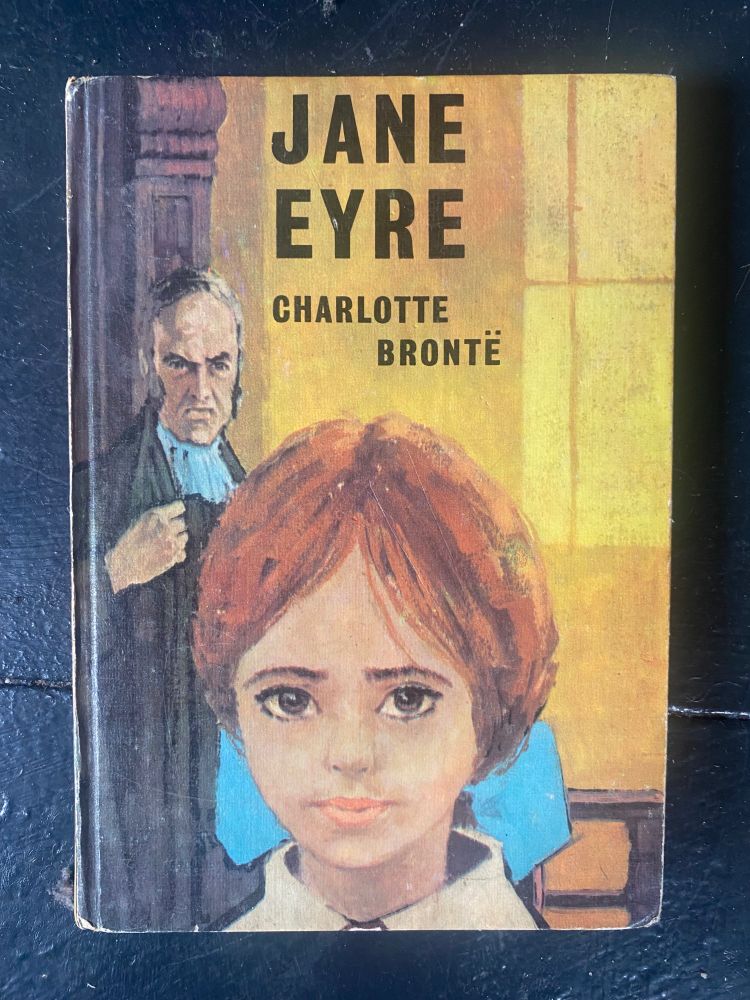 Jane Eyre by Charlotte Bronte. Jane has a haircut like, no, I can’t say it. She looks lurid and sad. A bad man behind her is looking very bad.