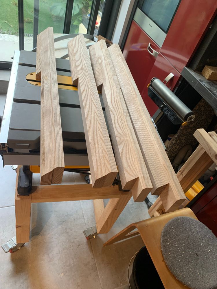 Four console legs made from glued planks and then cut diagonally 