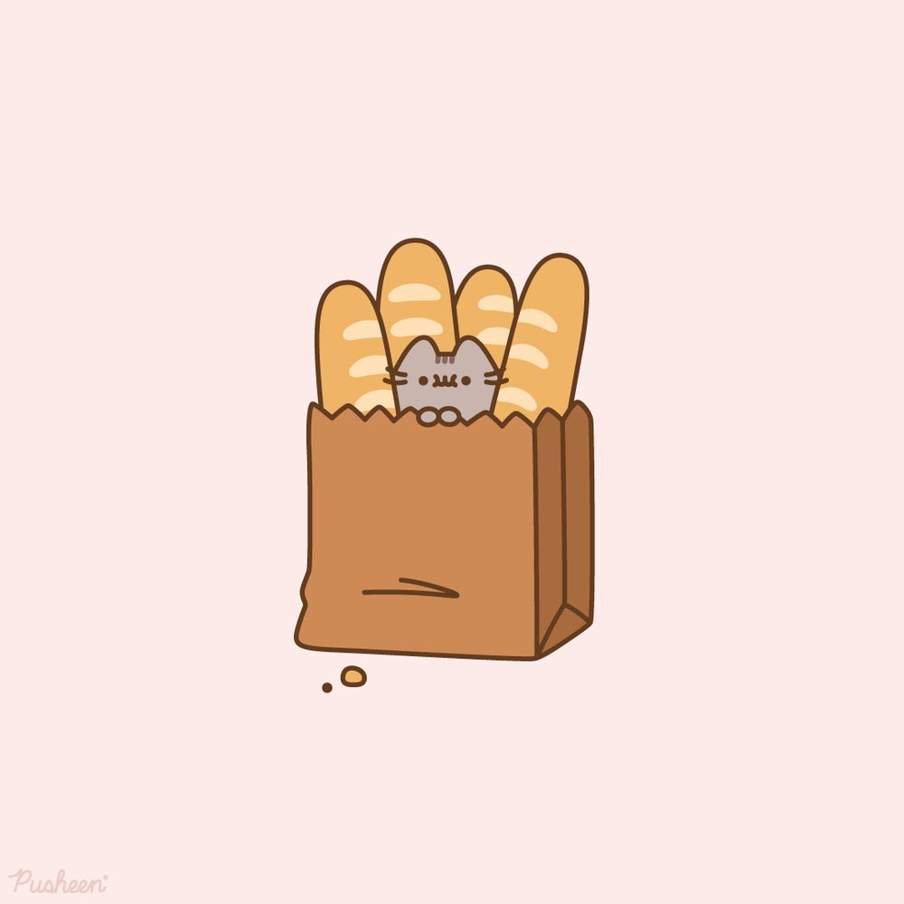 Pusheen sits in a brown paper shopping bag. She is surrounded by baguettes.