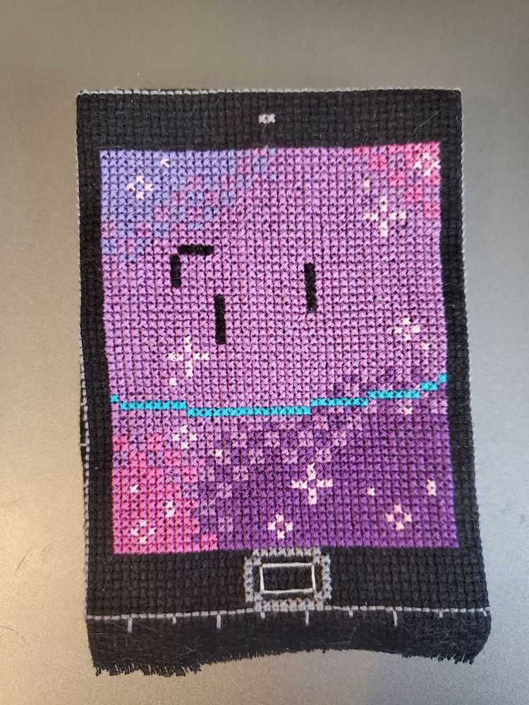 The front of MePad. He's smiling subtly and each of his corners has other colors that fade into a light purple in the middle. Light pink sparkles dot his face like freckles.