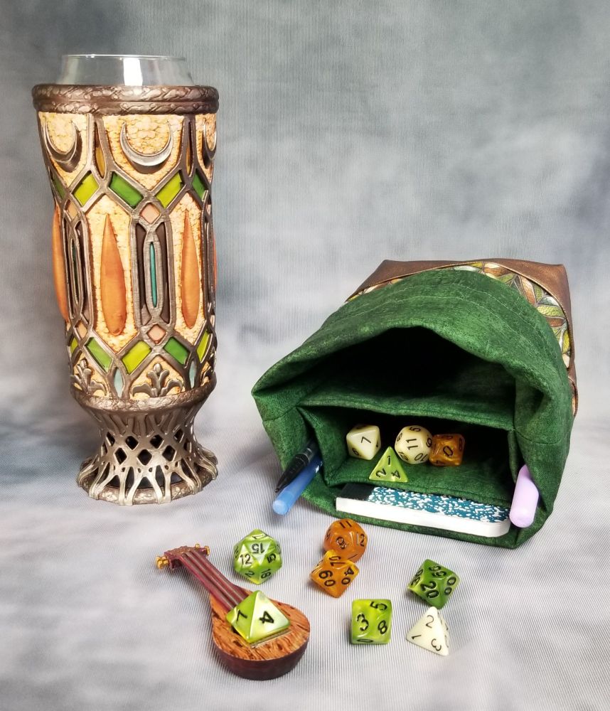 Large dice bag lying on its side to show off the pockets,  light elf mythic mug can holder, light bardic inspiration lute