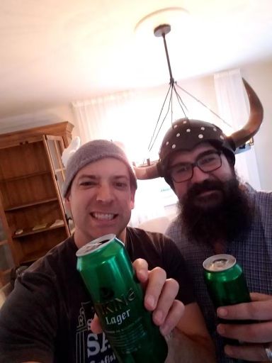 Two idiots drinking beer, one in a Viking helm.