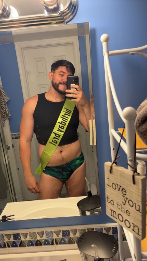Me with a birthday brat sash while in a Speedo and crop top