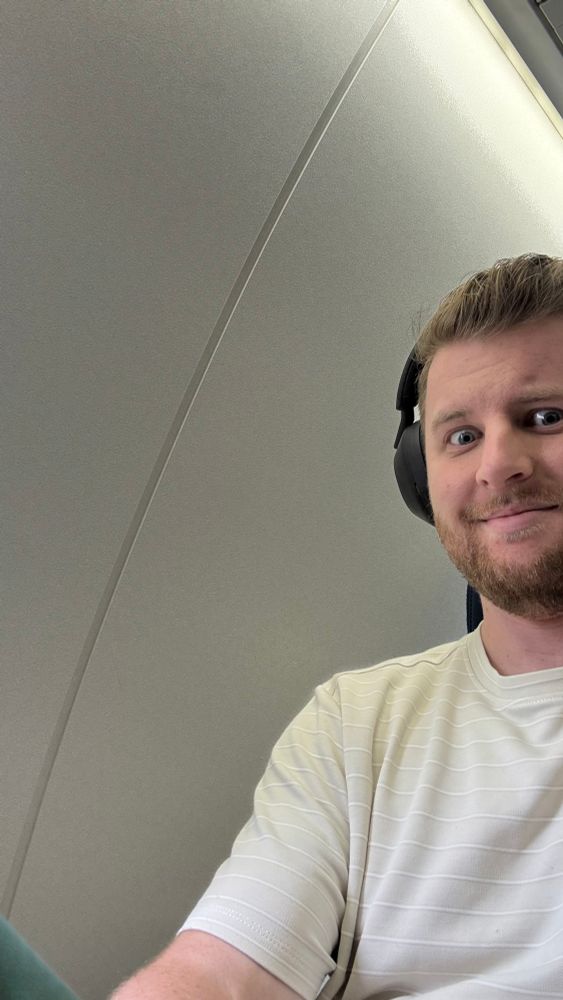 A selfie of me showing the wall next to my "window" seat, which does not have a window 