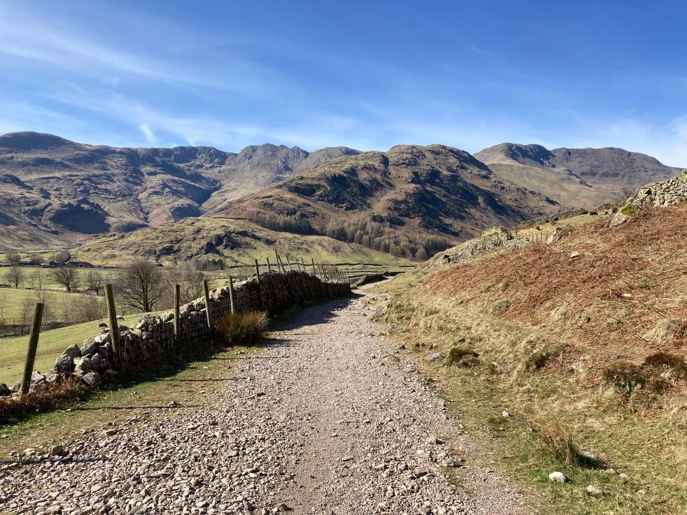 View up a footpath to some knobbly mountains