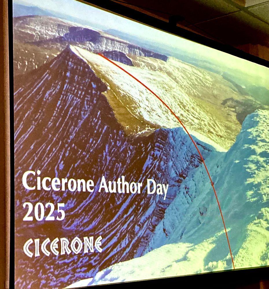 Photo of a projected PowerPoint slide with a picture of the Brecon Beacons mountains and the caption ‘Cicerone Author Day 2025’