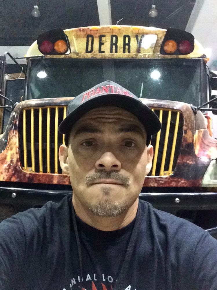 Armando Munoz in front of a bloody bus to Derry, Maine.