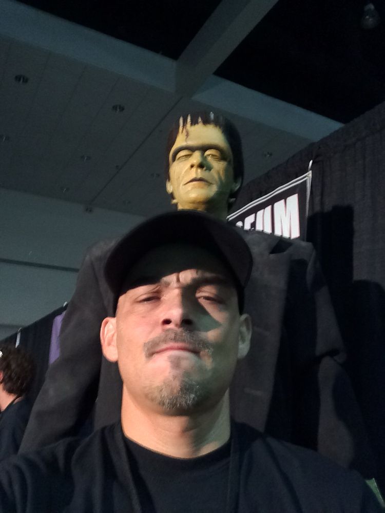 Armando Munoz standing before the Frankenstein Monster.