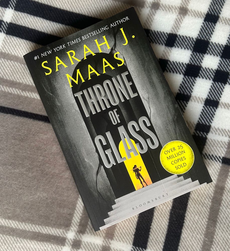Throne of Glass, by Sarah J Maas, over a check background.