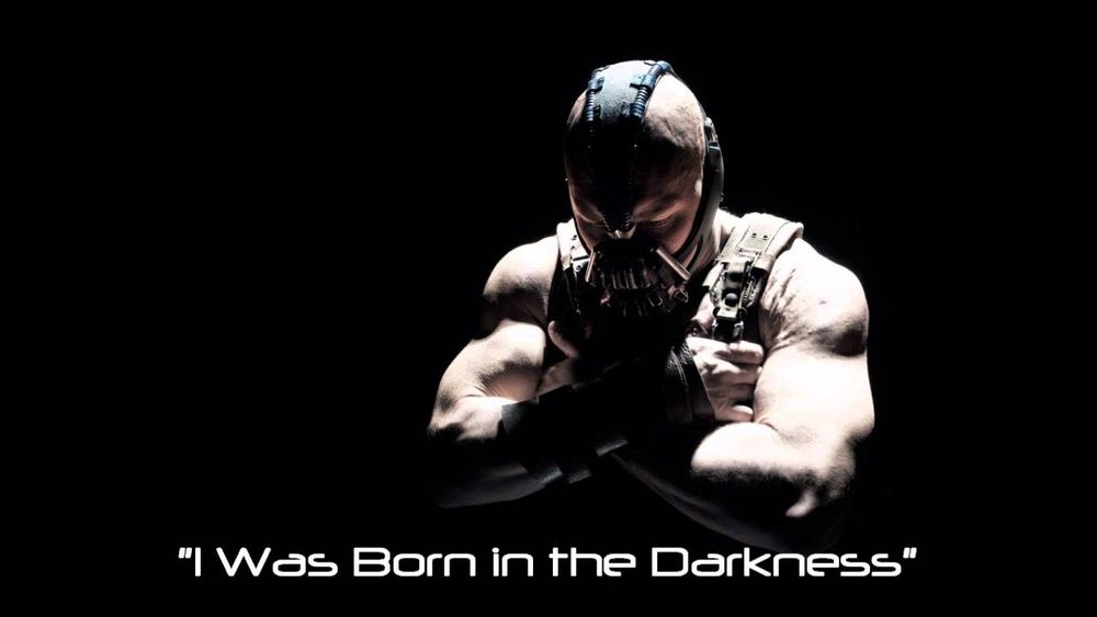 sufficiently edgy picture of Bane from Dark Knight Rises with the caption "I Was Born in the Darkness" 