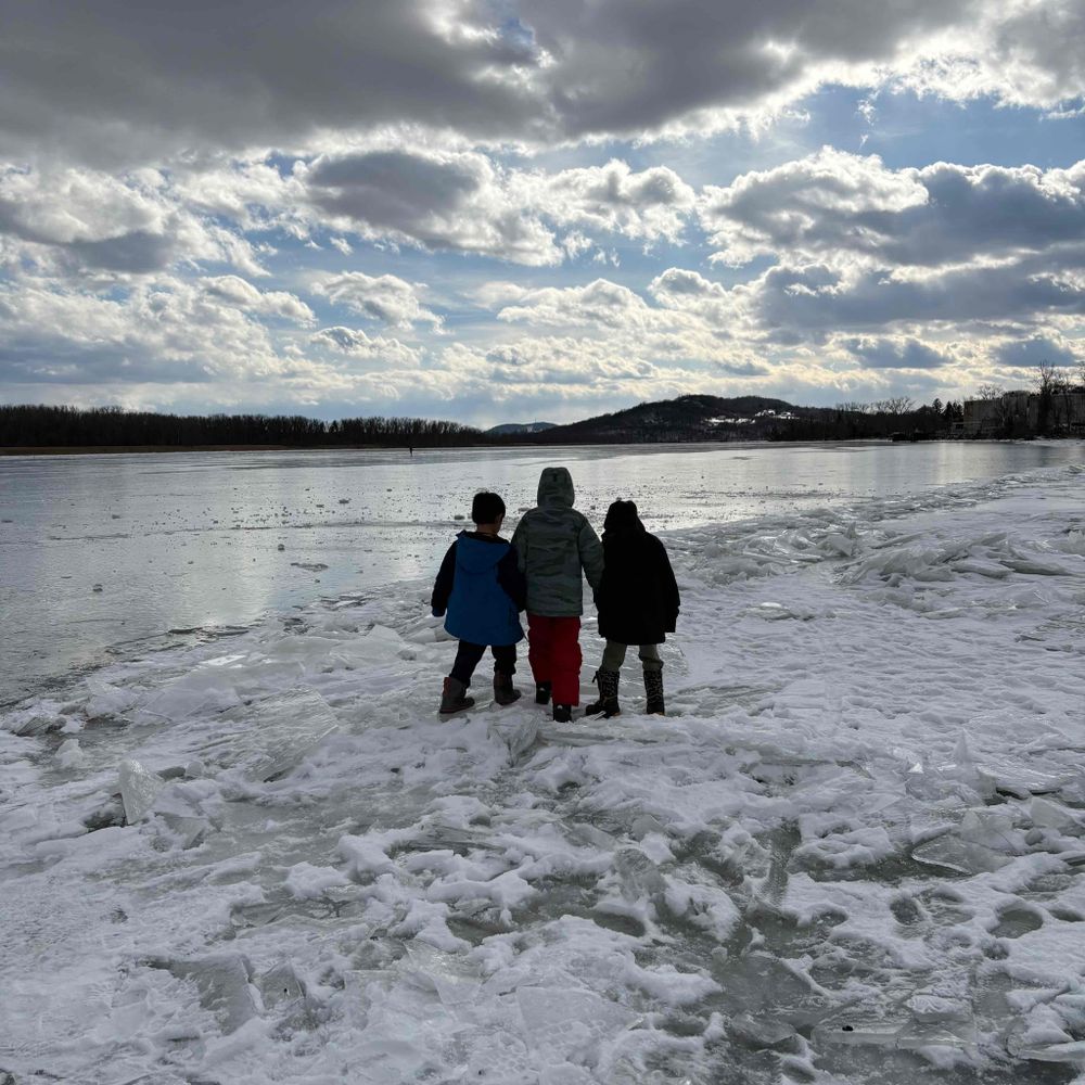 three boys walking on the ice