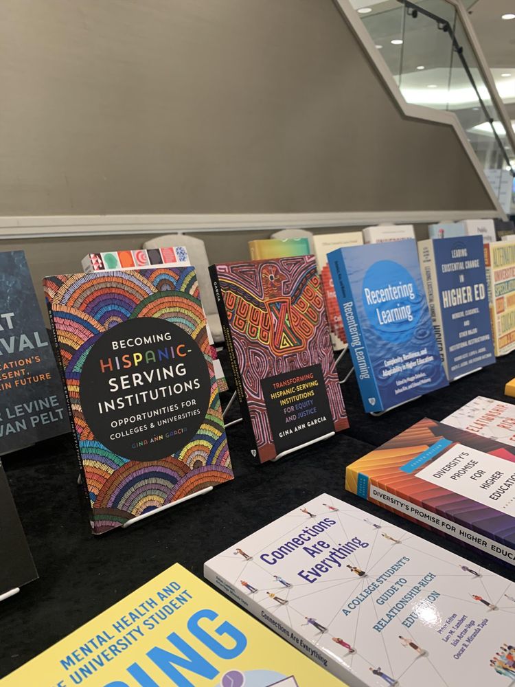 A detail of the higher ed book display at the Hopkins Press table at ASHE 2025
