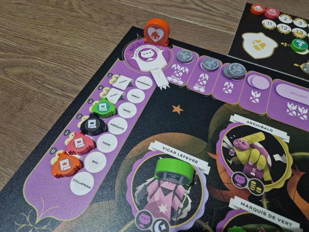 A teaser shot of a corner of a board. Two bugs are on spaces near the center, one of whom has been executed given the guillotine marker thats been placed on them. Coins and pieces are arrayed everywhere