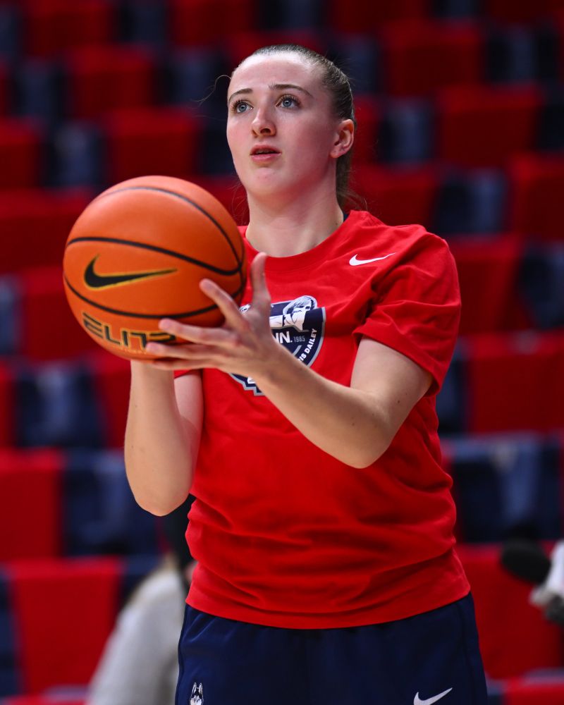 Allie Ziebel pregame in a ruby Geno and CD 40th celebration shirt 