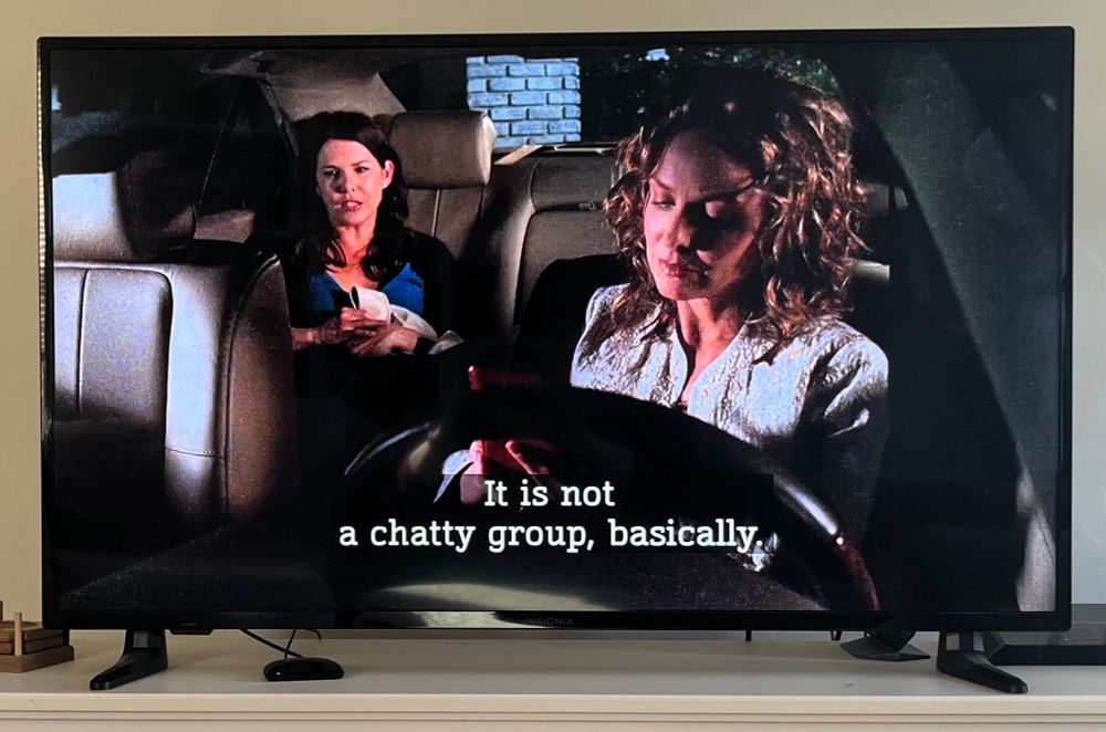 Photo of a video still from Gilmore Girls season 6, episode 22 (season finale). The phot shows to women in a car. The first seated in the back seat is Lorelai Gilmore (Lauren Graham) being psychoanalyzed by Carolyn (Melora Hardin) who’s seated in the driver’s seat. This scene follows after the group leaves from a dinner with Lorelai’s parents.