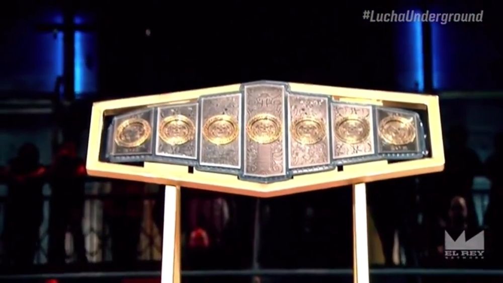 The Gift of the Gods Championship being displayed in a Lucha Underground ring.